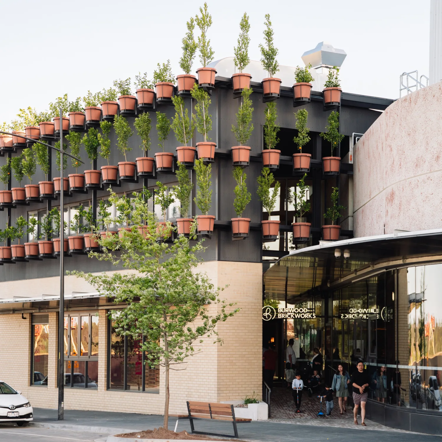 Exterior of Burwood Brickworks shopping Centre with plants in pots mounted to the walls