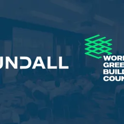 Cundall and World Green Building Council logos over a conference event scene with seated attendees and a presentation screen in the background.