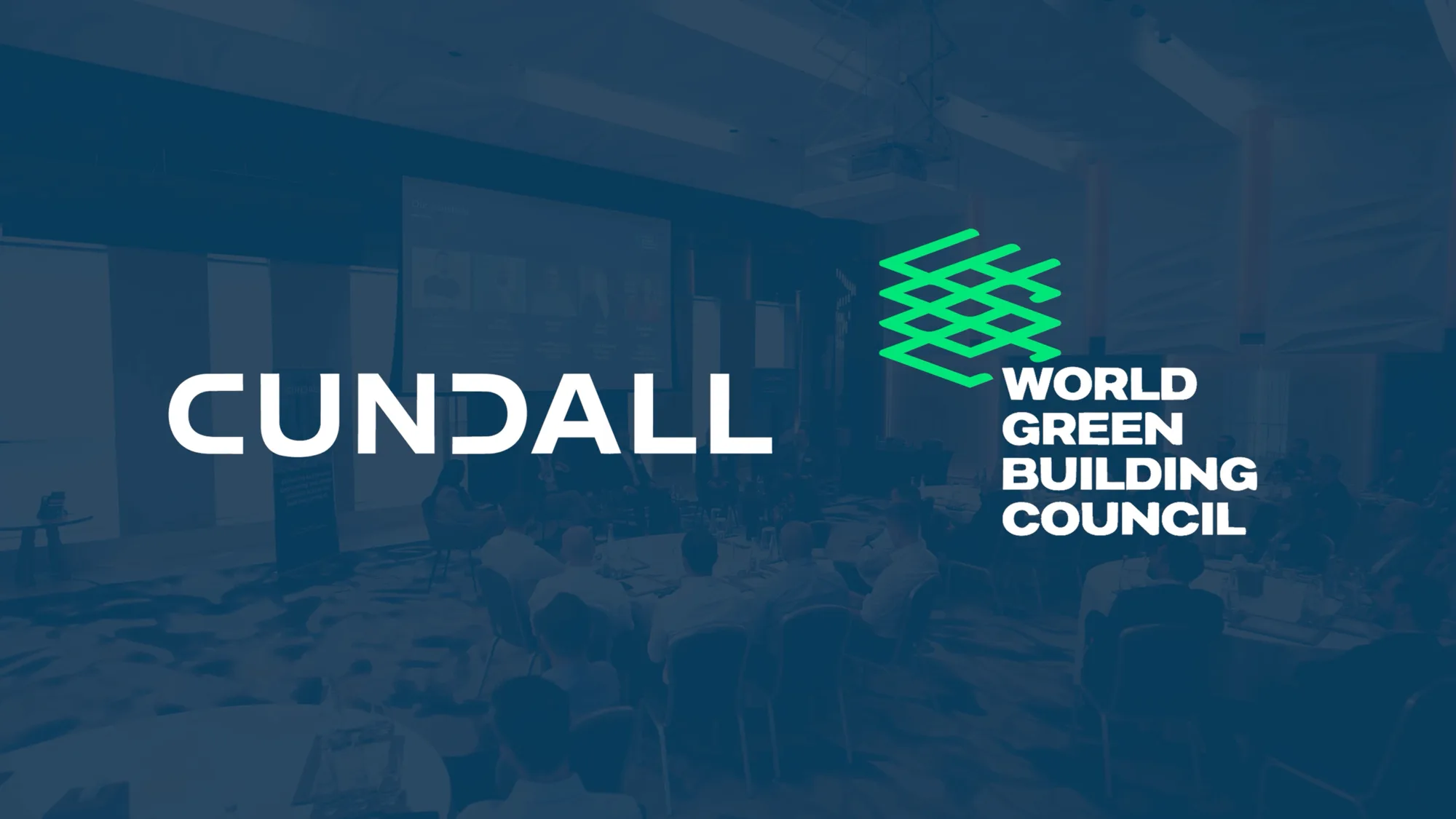 Cundall and World Green Building Council logos over a conference event scene with seated attendees and a presentation screen in the background.