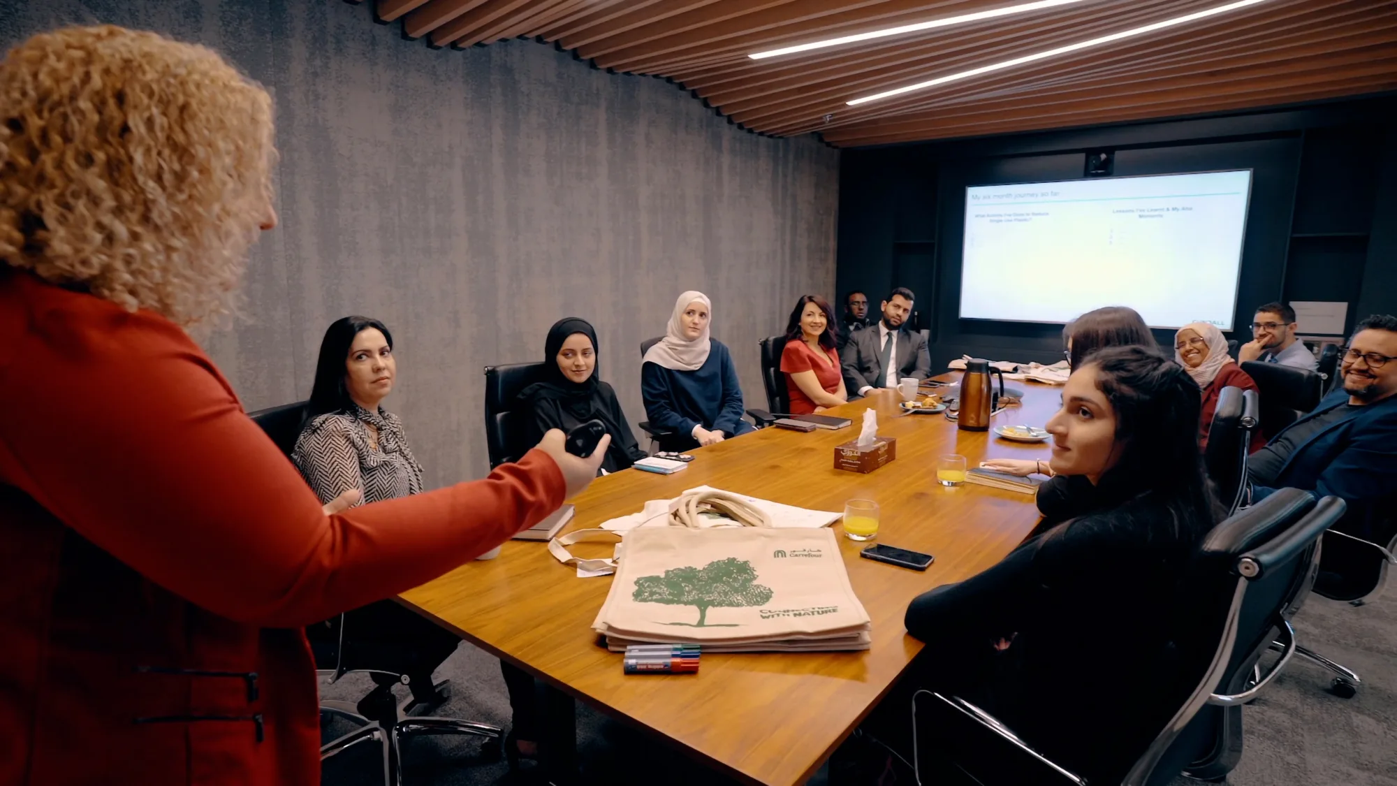 A group of individuals having a conversation in the boardroom of our Cundall dubai office.