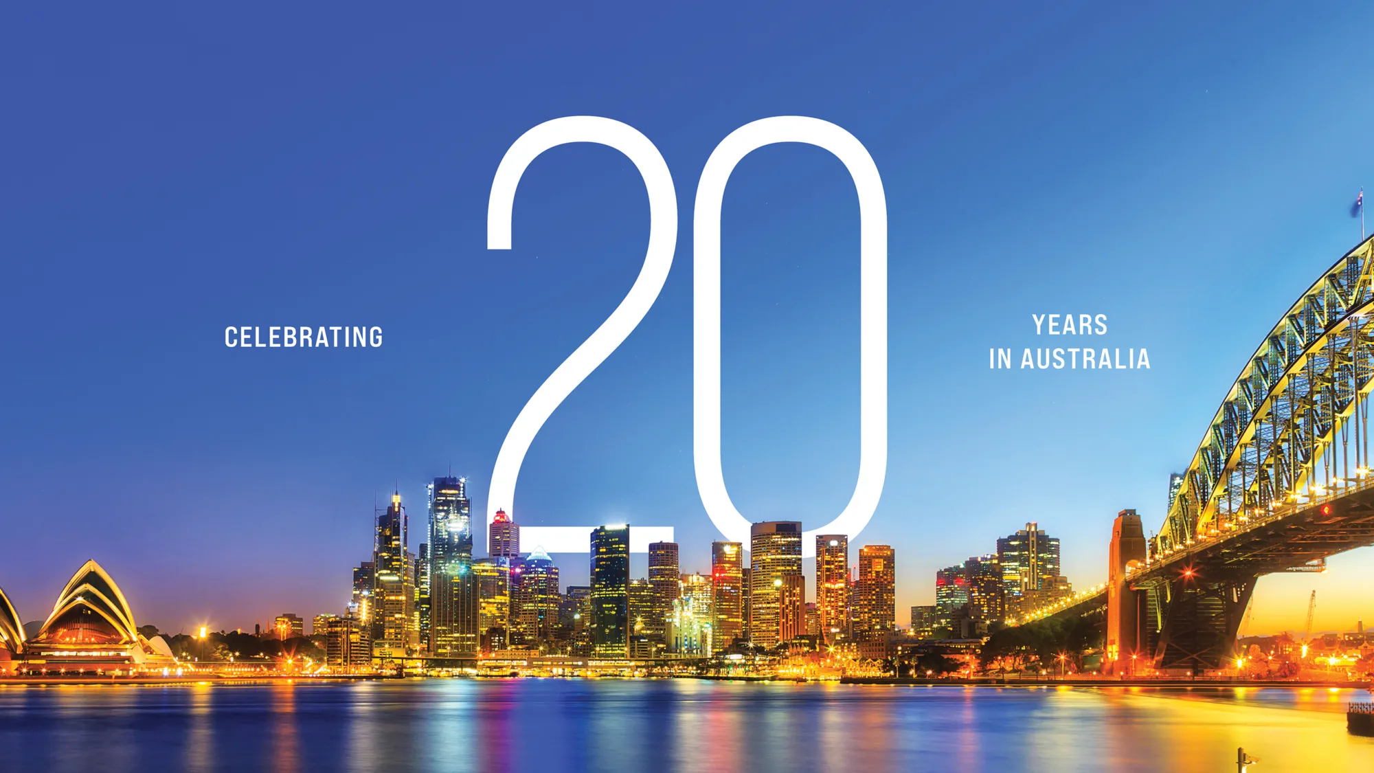 Night time shot of Sydney with the words celebrating 20 years in Australia