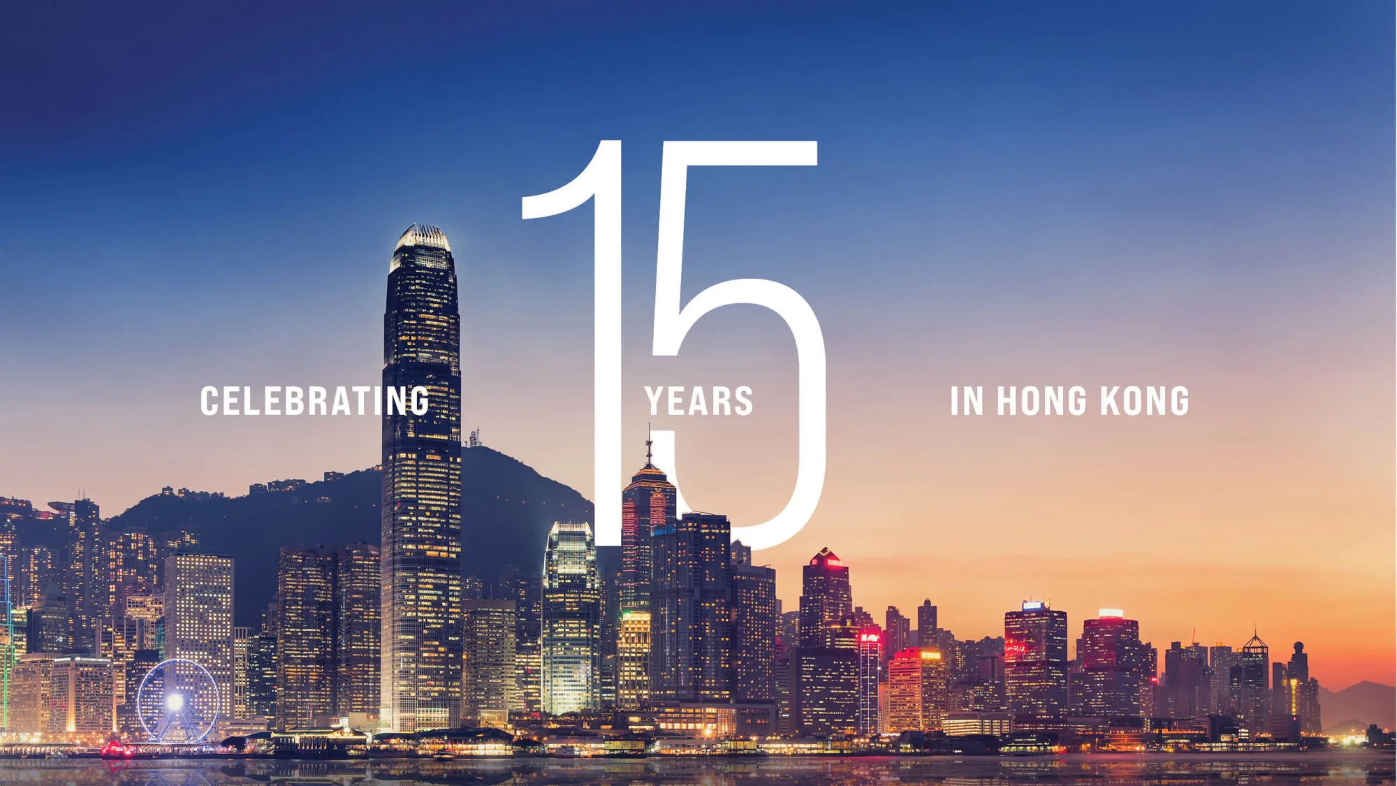Hong Kong skyline with "Celebrating 15 years in Hong Kong" text overlay