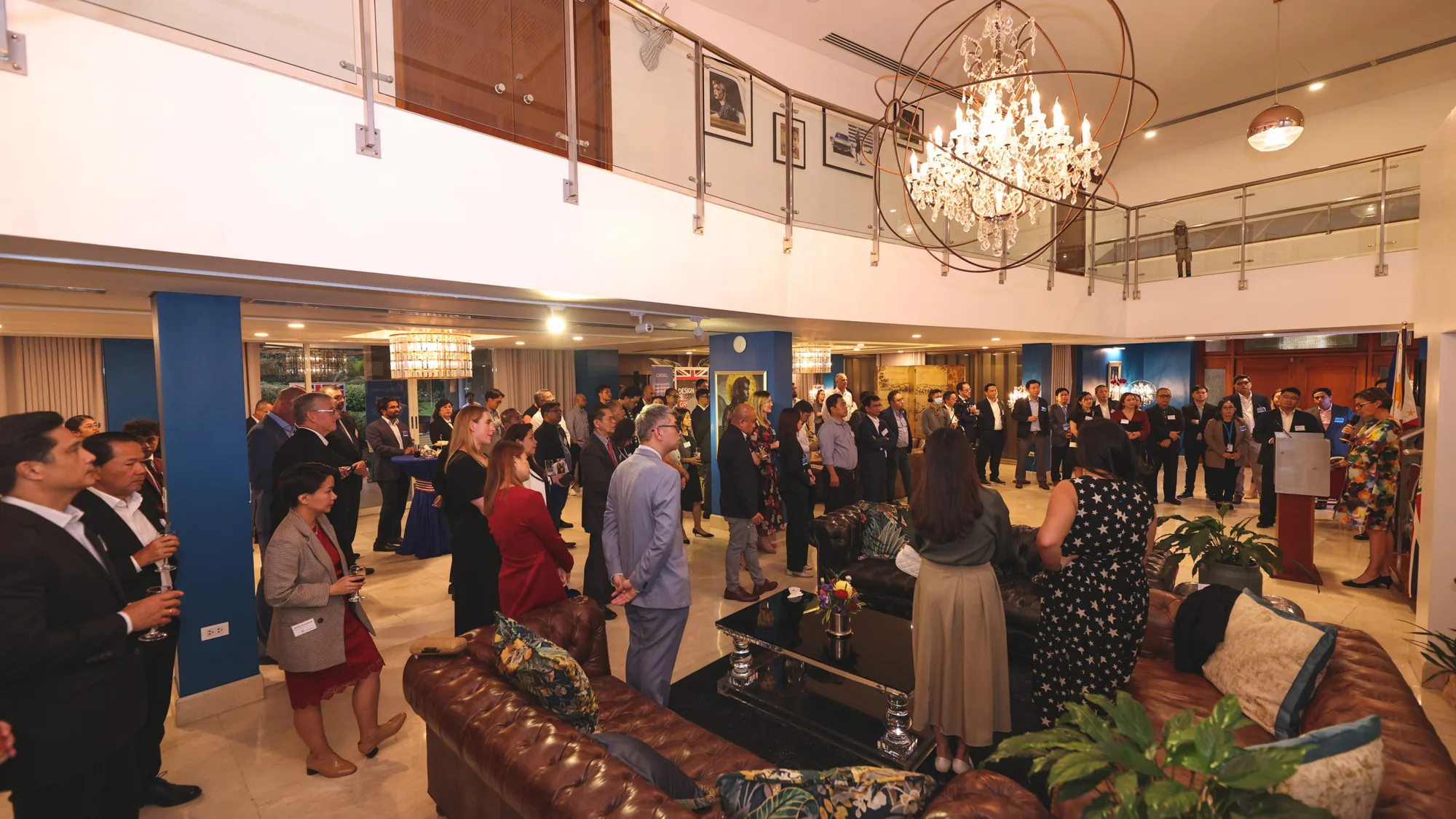 Guests gathered in the Embassy listening to Laure Beaufils give opening speech at party