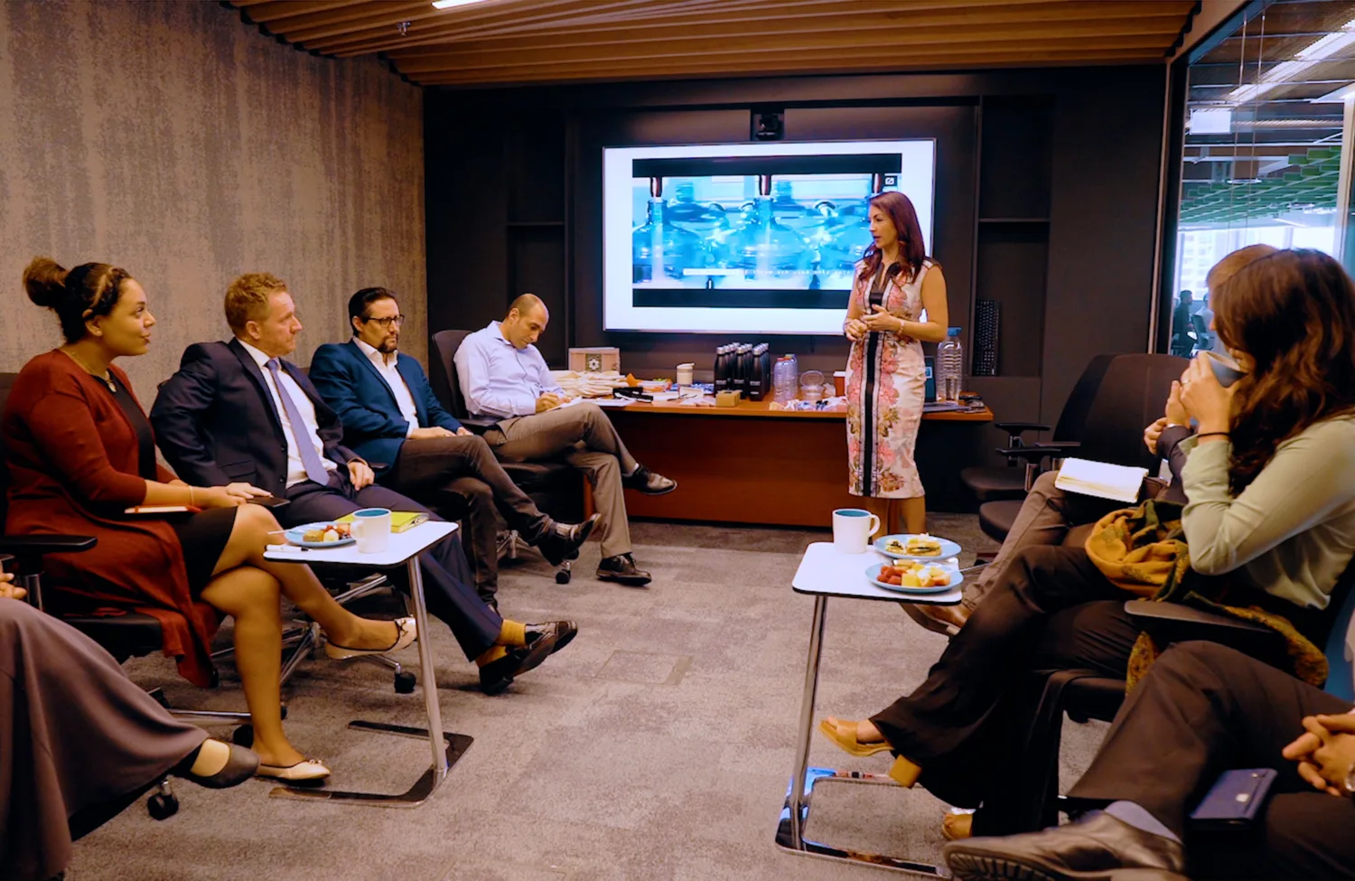 A group of individuals having a conversation in the boardroom of our Cundall dubai office.