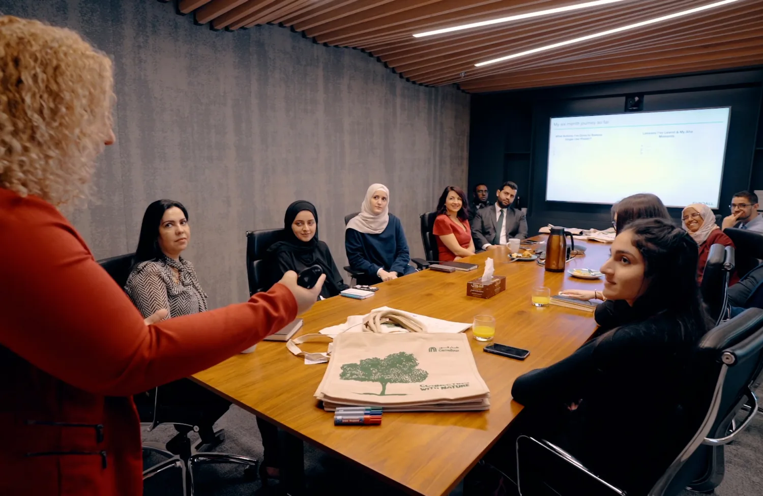 A group of individuals having a conversation in the boardroom of our Cundall dubai office.