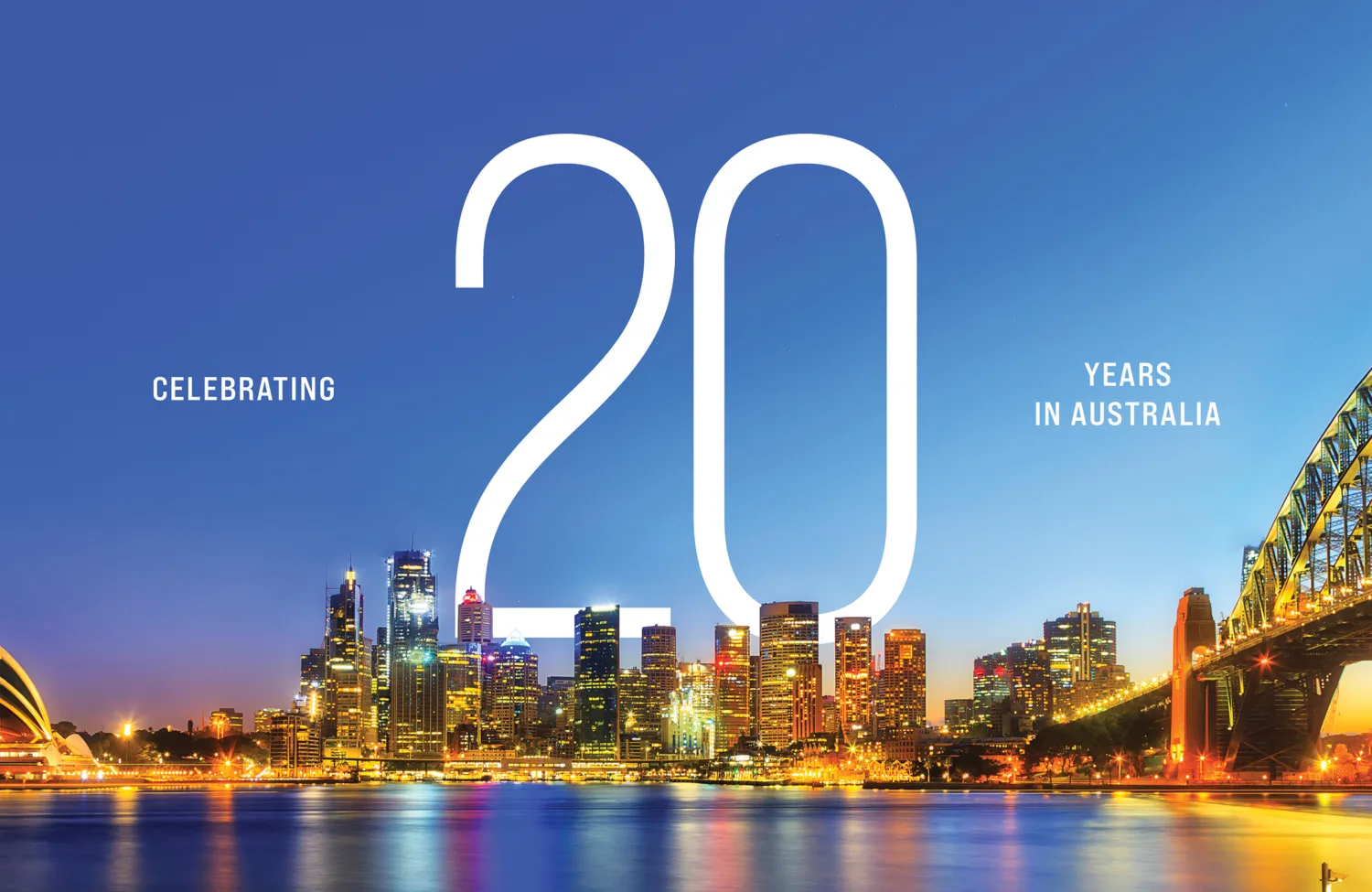 Night time shot of Sydney with the words celebrating 20 years in Australia