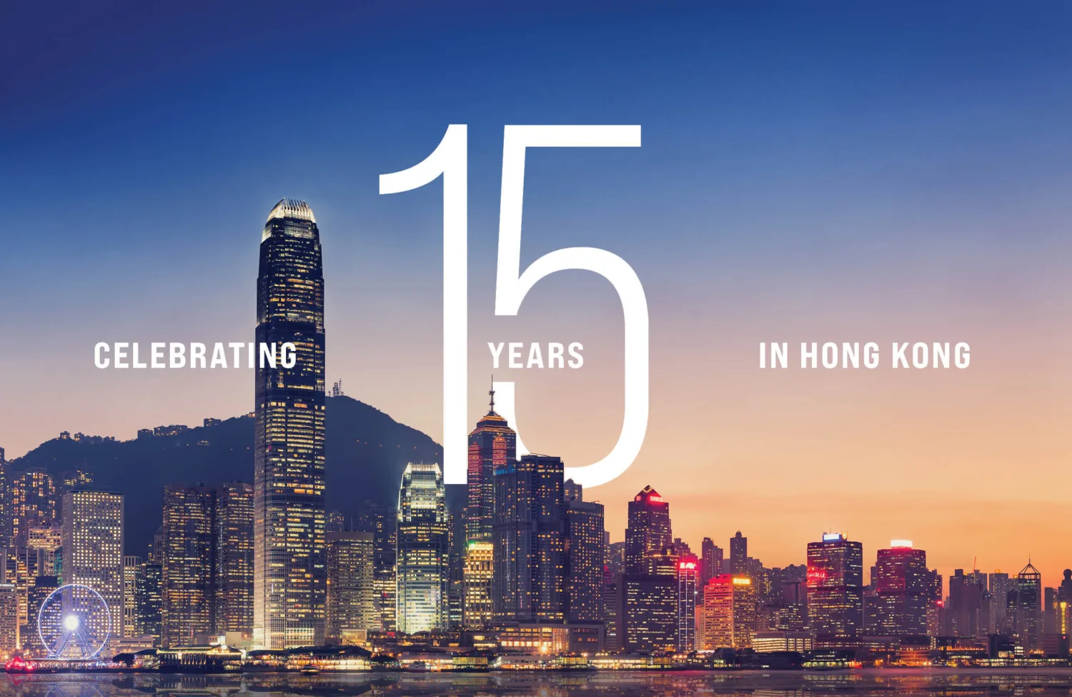 Hong Kong skyline with "Celebrating 15 years in Hong Kong" text overlay