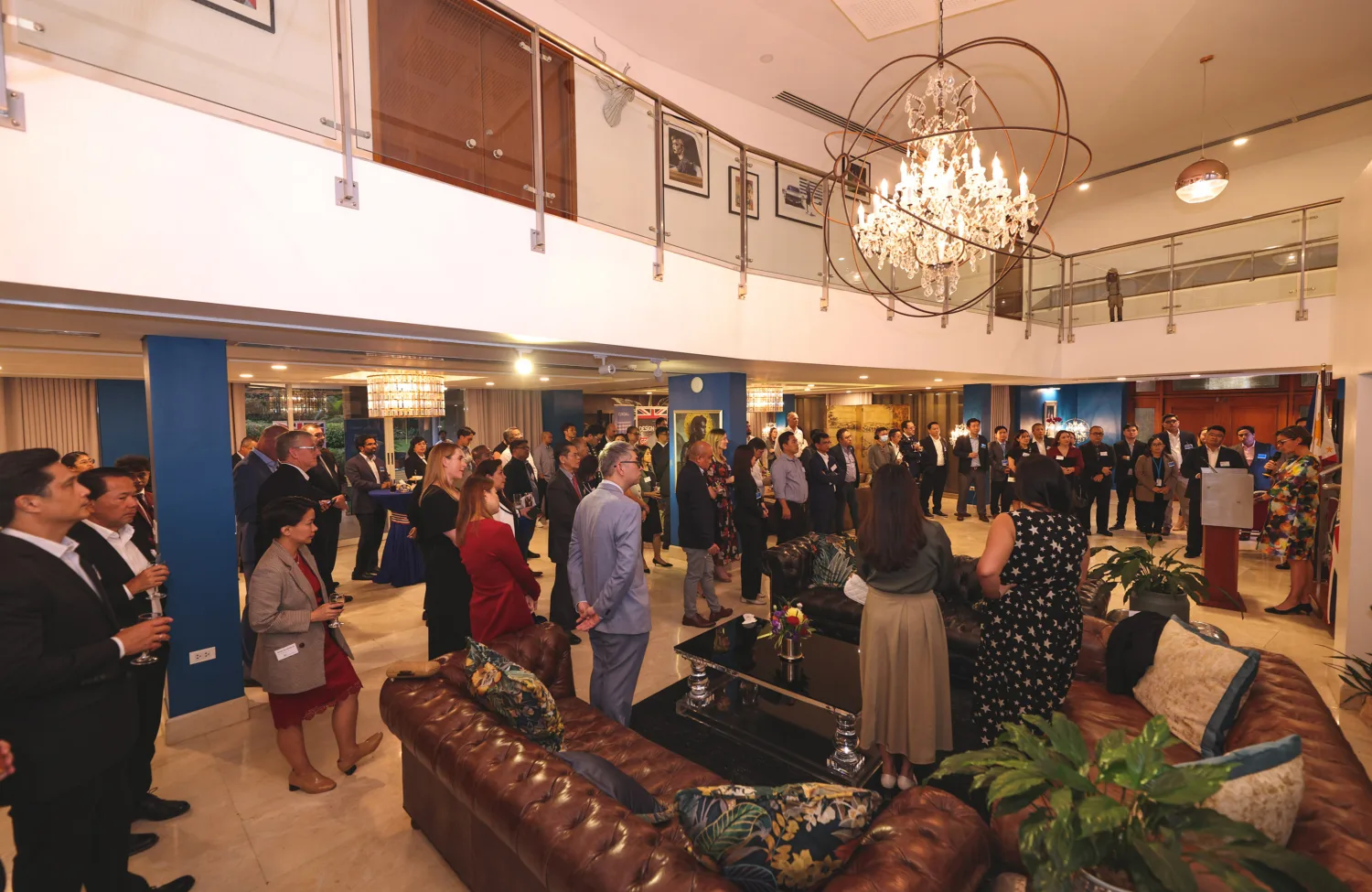 Guests gathered in the Embassy listening to Laure Beaufils give opening speech at party