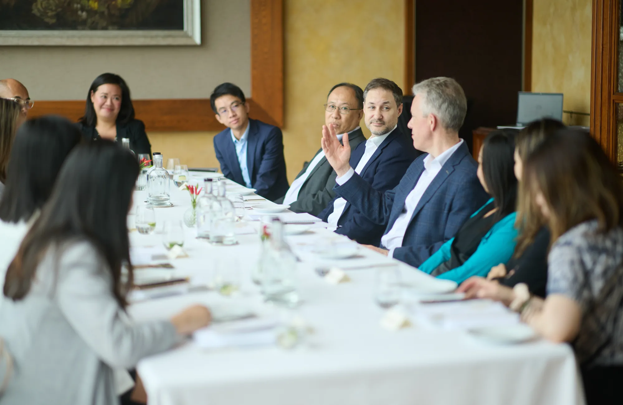 A round table discussion with people and a long white table